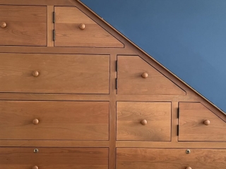 Cherry Cabinetry Tucked Beneath Stairway
