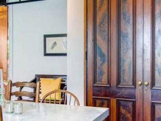 Reclaimed Victorian Parlor Doors used for Pantry. Copper-clad Barn Doors to Living Room