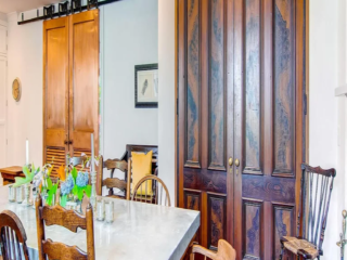 Reclaimed Victorian Parlor Doors used for Pantry. Copper-clad Barn Doors to Living Room