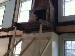 Second story floor removed with temporary supports for fireplaces